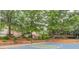 Community basketball court surrounded by lush green trees and landscaping at 2275 Black Pebble Cir, Buford, GA 30519