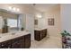 This bathroom offers dark wood cabinets, double sinks, tile floors, and a separate toilet room at 2275 Black Pebble Cir, Buford, GA 30519