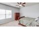Comfortable bedroom includes a ceiling fan, dresser, and a large window letting in natural light at 2275 Black Pebble Cir, Buford, GA 30519