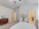 Bedroom with neutral walls and vaulted ceilings includes a dressing table and walk-in closet access at 2275 Black Pebble Cir, Buford, GA 30519