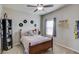 Bedroom with hardwood floors features a ceiling fan, a window, and is decorated with personal touches at 2275 Black Pebble Cir, Buford, GA 30519