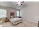 Bright bedroom features neutral walls, carpet floors, ceiling fan, and windows allowing for ample natural light at 2275 Black Pebble Cir, Buford, GA 30519
