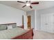 Cozy bedroom featuring a ceiling fan, closet space and adjoining bathroom door at 2275 Black Pebble Cir, Buford, GA 30519
