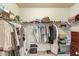 Walk-in closet offers ample hanging storage with wire shelving, along with a chest of drawers for folded items at 2275 Black Pebble Cir, Buford, GA 30519
