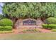 Stone community entrance sign with beautiful landscaping and mature trees at Willow Leaf Community at 2275 Black Pebble Cir, Buford, GA 30519