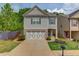 Charming two-story home with a well-manicured lawn and a welcoming front entrance and a two car garage at 2275 Black Pebble Cir, Buford, GA 30519