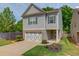 Charming two-story home with a well-manicured lawn and a welcoming front entrance and a two car garage at 2275 Black Pebble Cir, Buford, GA 30519