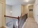 Upstairs hallway with carpeted flooring, wooden railing, and a view of the staircase below at 2275 Black Pebble Cir, Buford, GA 30519