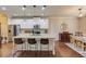 Bright eat-in kitchen with granite counters, stainless steel appliances, and center island with bar stool seating at 2275 Black Pebble Cir, Buford, GA 30519