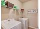 Practical laundry room with modern appliances and ample shelving at 2275 Black Pebble Cir, Buford, GA 30519