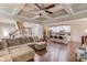 Open-concept living room with hardwood floors that flows into the kitchen with a center island at 2275 Black Pebble Cir, Buford, GA 30519