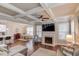 Open-concept living room with fireplace, coffered ceilings, and hardwood floors at 2275 Black Pebble Cir, Buford, GA 30519