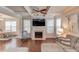 Bright living room featuring a fireplace, coffered ceilings, hardwood floors, and natural light at 2275 Black Pebble Cir, Buford, GA 30519