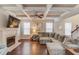 Spacious living room with a fireplace, coffered ceiling, and hardwood floors at 2275 Black Pebble Cir, Buford, GA 30519