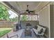 Covered outdoor patio with a grill, comfortable seating, and a ceiling fan at 2275 Black Pebble Cir, Buford, GA 30519