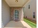 Covered patio with brick siding and a door into the home at 2275 Black Pebble Cir, Buford, GA 30519