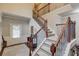 Carpeted staircase with wooden railings, iron spindles, and view of the home's entrance at 2275 Black Pebble Cir, Buford, GA 30519