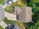 Aerial view of a two-story home showing the roof, driveway, and surrounding mature trees at 3420 Griffin Way, Cumming, GA 30040