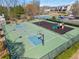 Outdoor basketball court features two hoops, playground, and green surface at 3420 Griffin Way, Cumming, GA 30040