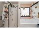 This bathroom features an elegant tub, standing shower and modern decor at 3420 Griffin Way, Cumming, GA 30040