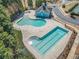 Aerial view of the community pool featuring different pool areas and blue clubhouse at 3420 Griffin Way, Cumming, GA 30040