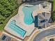 Aerial view of the community pool featuring different pool areas and blue clubhouse at 3420 Griffin Way, Cumming, GA 30040