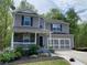 Attractive two-story home with a welcoming front porch and attached two-car garage at 3420 Griffin Way, Cumming, GA 30040