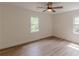 Bedroom features a ceiling fan, hardwood floors, and plenty of natural light at 525 Rosemont Dr, Decatur, GA 30032