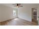 Bright bedroom with hardwood floors, a ceiling fan, and a window to the yard at 525 Rosemont Dr, Decatur, GA 30032