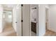 Hallway with wood floors leads to a bathroom with a vanity and decorative mirror at 525 Rosemont Dr, Decatur, GA 30032