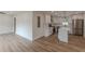 An open concept kitchen with stainless appliances and an island, and an adjacent living area at 525 Rosemont Dr, Decatur, GA 30032