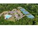 Overhead view of community amenities including swimming pool, tennis courts, clubhouse, and parking, all surrounded by mature trees at 6240 Vista Crossing Way, Cumming, GA 30028