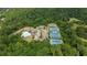 Aerial view of community amenities featuring a pool, clubhouse, and tennis courts surrounded by lush trees at 6240 Vista Crossing Way, Cumming, GA 30028