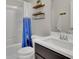 Well-lit bathroom with a shower, toilet, single sink, and storage shelves at 6240 Vista Crossing Way, Cumming, GA 30028