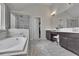 Well-lit bathroom features a double vanity, a separate glass-enclosed shower and a large soaking tub at 6240 Vista Crossing Way, Cumming, GA 30028