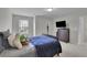 Bright bedroom featuring plush pillows, TV, and a window overlooking a home at 6240 Vista Crossing Way, Cumming, GA 30028