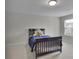 A well-lit bedroom features a large window and neutral walls and floors at 6240 Vista Crossing Way, Cumming, GA 30028
