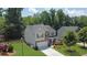 Charming two-story home with a well-kept lawn, landscaping, two car garage and a paved driveway at 6240 Vista Crossing Way, Cumming, GA 30028