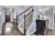 Inviting foyer with hardwood floors, staircase, and stylish decor at 6240 Vista Crossing Way, Cumming, GA 30028