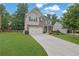 Beautiful two-story home with a large driveway, lush landscaping, and a brick and siding exterior at 6240 Vista Crossing Way, Cumming, GA 30028