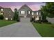 Beautiful two-story home with a large driveway, lush landscaping, and a brick and siding exterior at 6240 Vista Crossing Way, Cumming, GA 30028