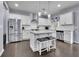 Open eat-in kitchen features stainless steel appliances, white cabinets, and hardwood floors at 6240 Vista Crossing Way, Cumming, GA 30028