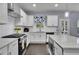 Modern kitchen with white cabinets, stainless steel appliances, granite countertops and hardwood floors at 6240 Vista Crossing Way, Cumming, GA 30028
