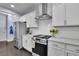 Bright, eat-in kitchen features stainless steel appliances, tile backsplash, and hardwood floors at 6240 Vista Crossing Way, Cumming, GA 30028