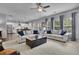 Open-concept living space connecting kitchen and living room with comfortable seating and lots of natural light at 6240 Vista Crossing Way, Cumming, GA 30028