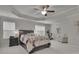 Spacious main bedroom featuring tray ceilings, neutral walls, and a ceiling fan at 6240 Vista Crossing Way, Cumming, GA 30028