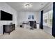 Spacious home office with a large window, comfortable seating, and ample desk space at 6240 Vista Crossing Way, Cumming, GA 30028
