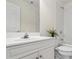 Well-lit bathroom featuring a white vanity, toilet, tub, and shower with white tile at 1444 Merrifield Ln, Marietta, GA 30062