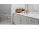 Bathroom featuring white cabinets, gold fixtures, and white tiling at 1444 Merrifield Ln, Marietta, GA 30062