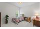 Bright bedroom featuring neutral walls and carpet, with a colorful bedspread at 1444 Merrifield Ln, Marietta, GA 30062